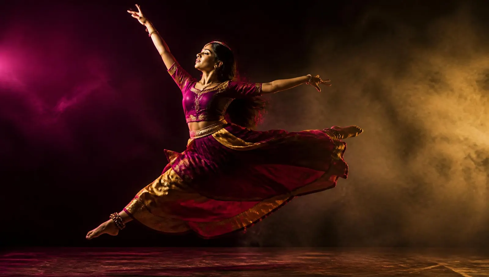 Dancer mid-leap in the Riddhi Dance Studio spotlight